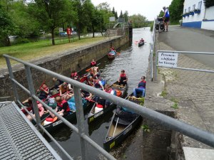 A group of canoeists entering a manually operated lock.